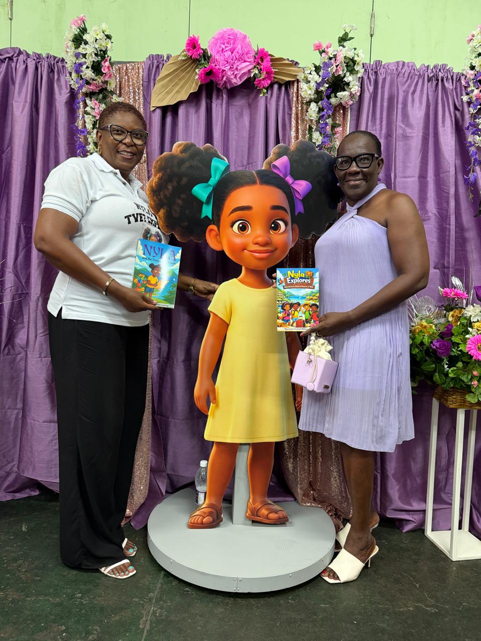 Pearlette Primus Hannaway at the May 30 2026 Nyla book launch beside her life-size animated character